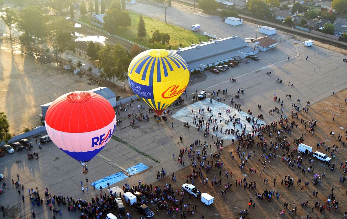 Cheers Aerial Media giving tethered rides with Valley Children's Healthcare and RE/MAX balloons ClovisFest